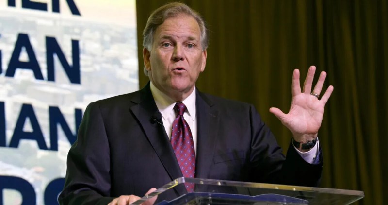 Mike Rogers standing at podium