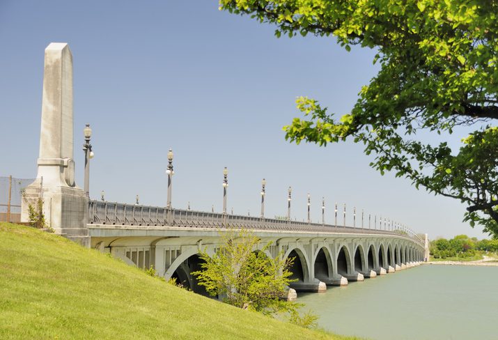 The historic Belle Isle Bridge traverses the Detroit River. Bell Isle Park is one of the best day trips from Detroit.
