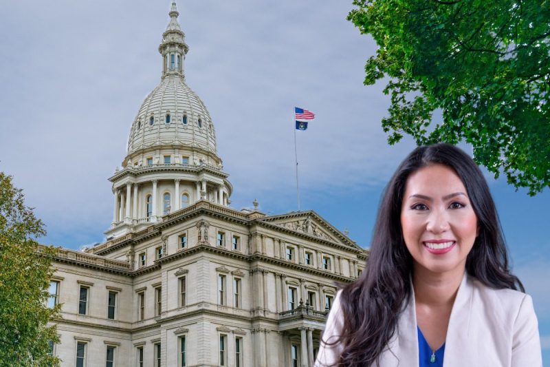 Photo of Mai Xiong in front of photo of Michigan Capitol Building