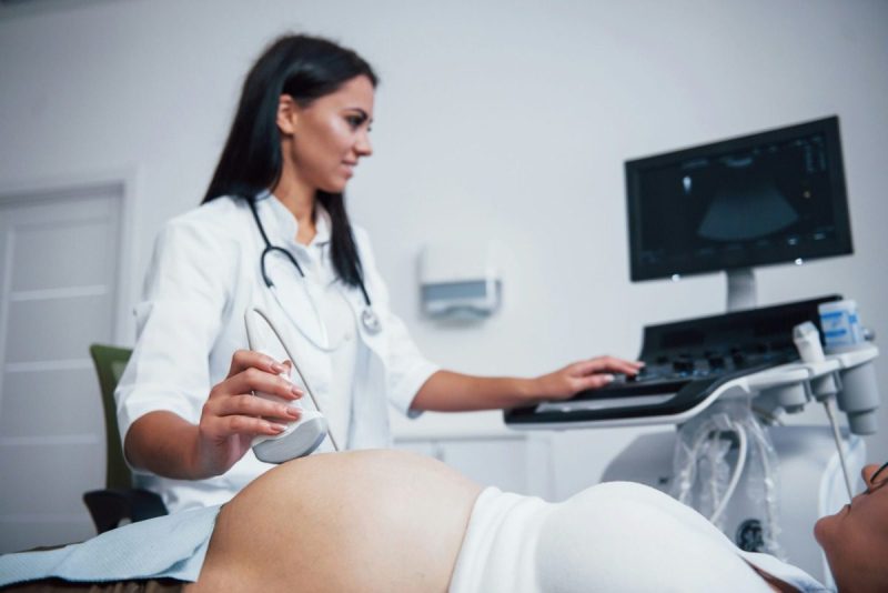 Woman receiving an ultrasound from a female doctor.