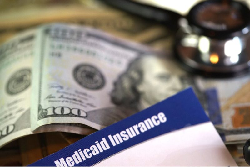 medicaid card in front of money