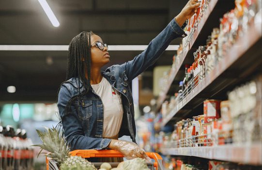 A young woman is shopping at a grocery store