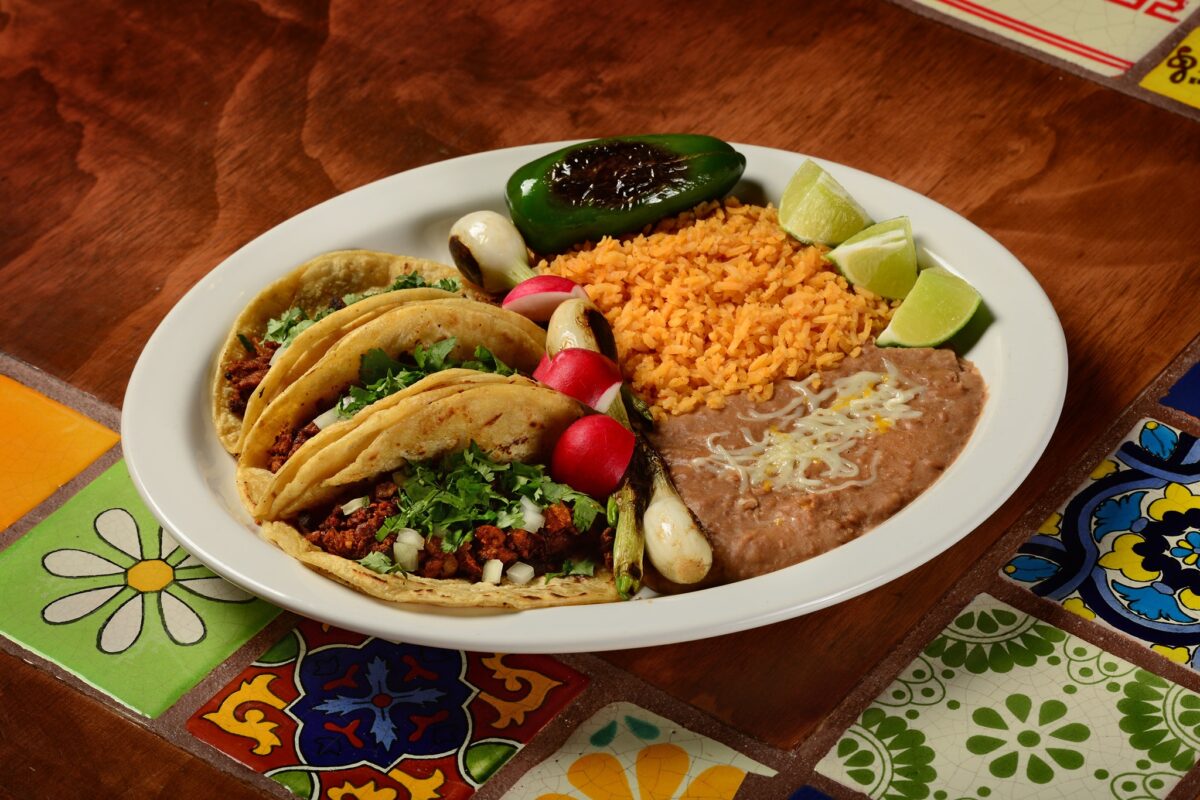A taco platter with a chile pepper, rice, beans, and lime wedges at Lindo Mexico, the best Mexican restaurant in Grand Rapids
